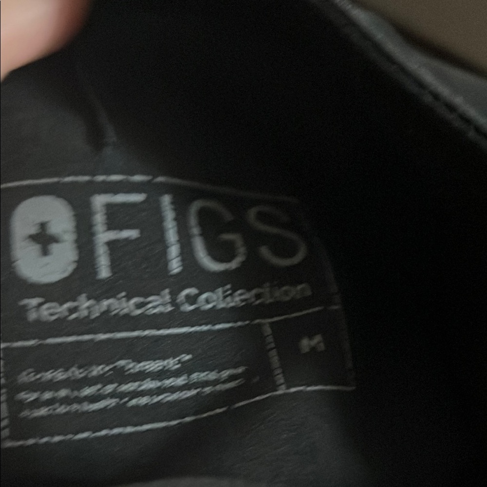 Figs
Black 
Medium scrub bottoms
Small zippers on legs
Pocket has a grey/black